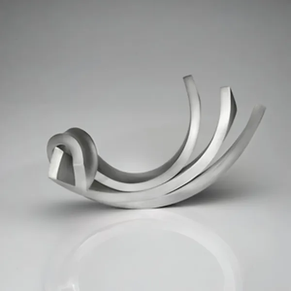 Curving silver sculpture with a knot and fan-shaped trailing bands